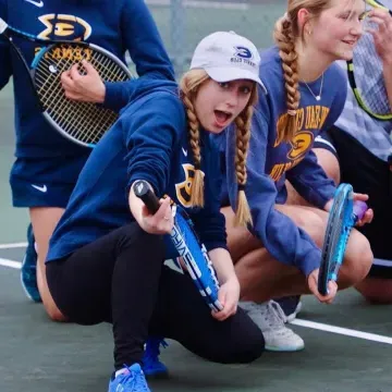 club tennis women silly pose with racquet 